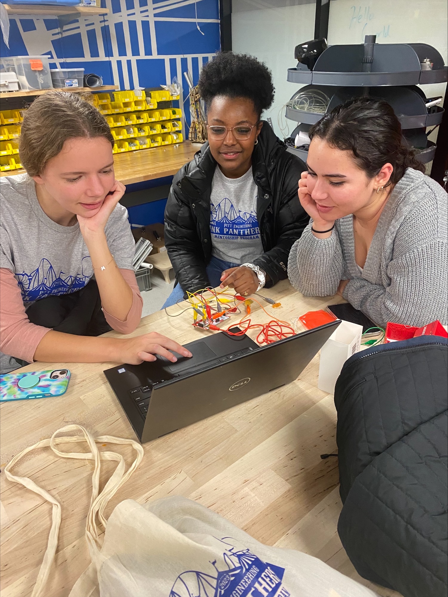 2 female students looking at a laptop 