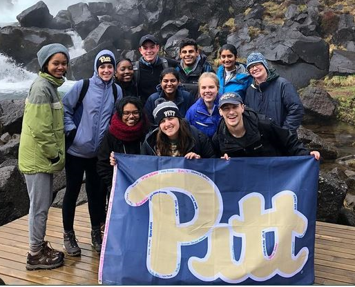 A group of students with a Pitt flag