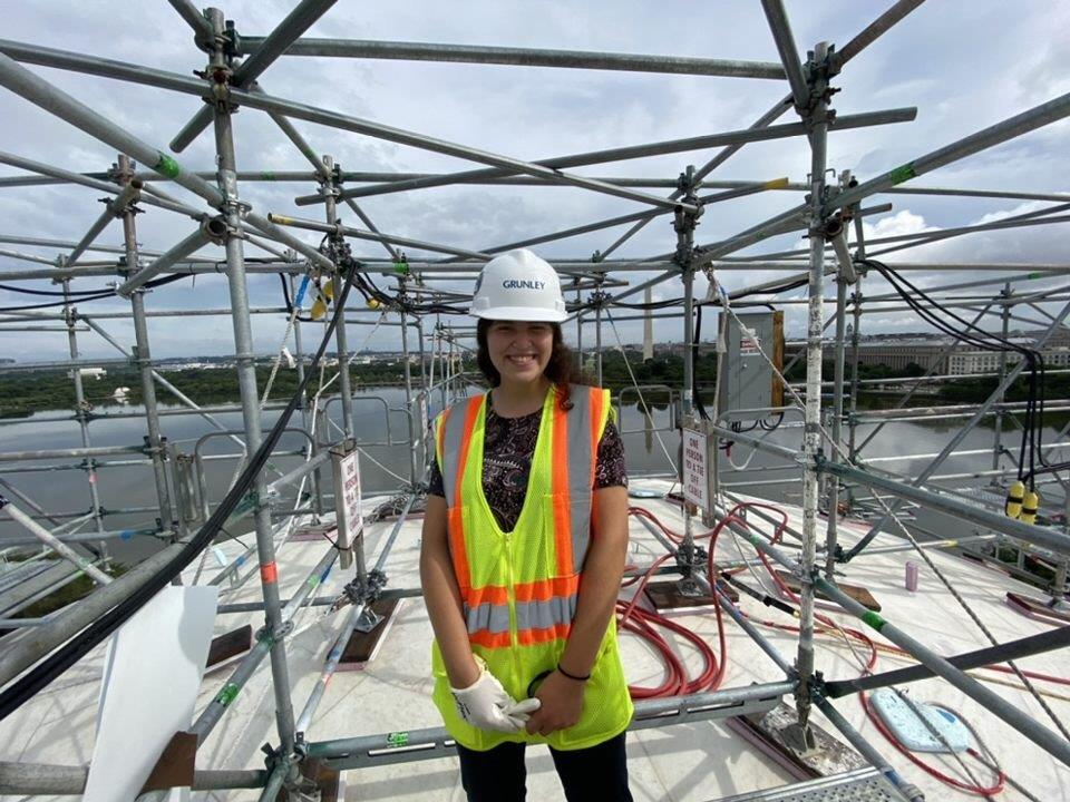 Shira Hackman on a job site in a yellow vest