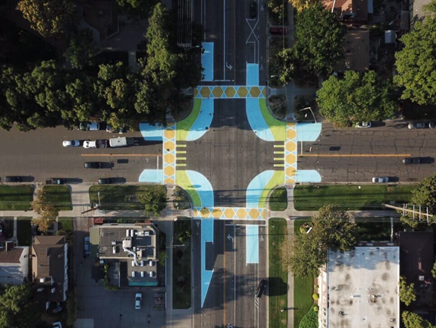 Aerial image of a intersection with fun abstract painted crosswalks