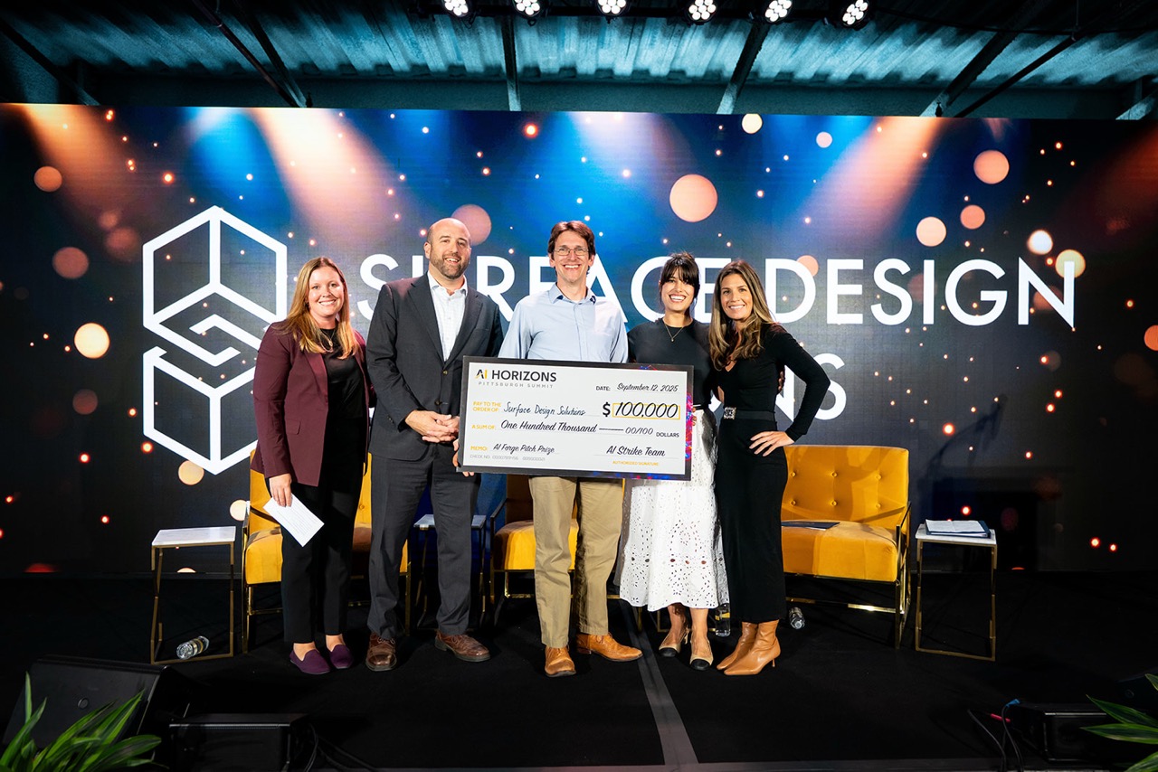 Tevis Jacobs (center) holding the award check at the AI Horizons Conference