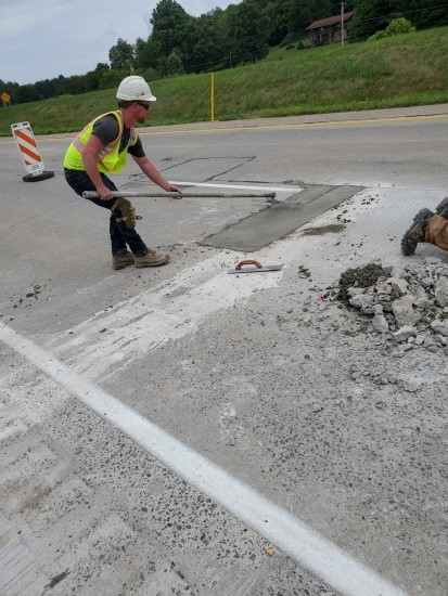 Worker patching concrete