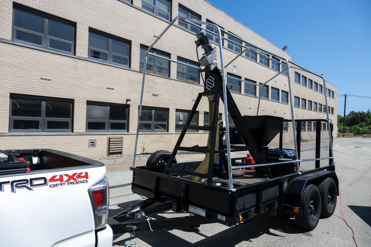 Prototype pothole-filling robot hitched to a truck