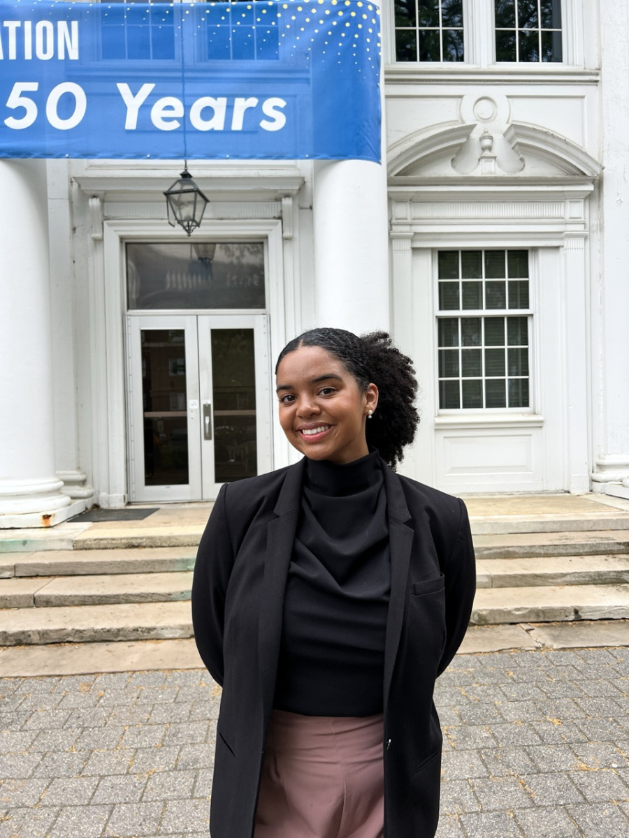 Hanna Armstrong smiles in front classic architecture