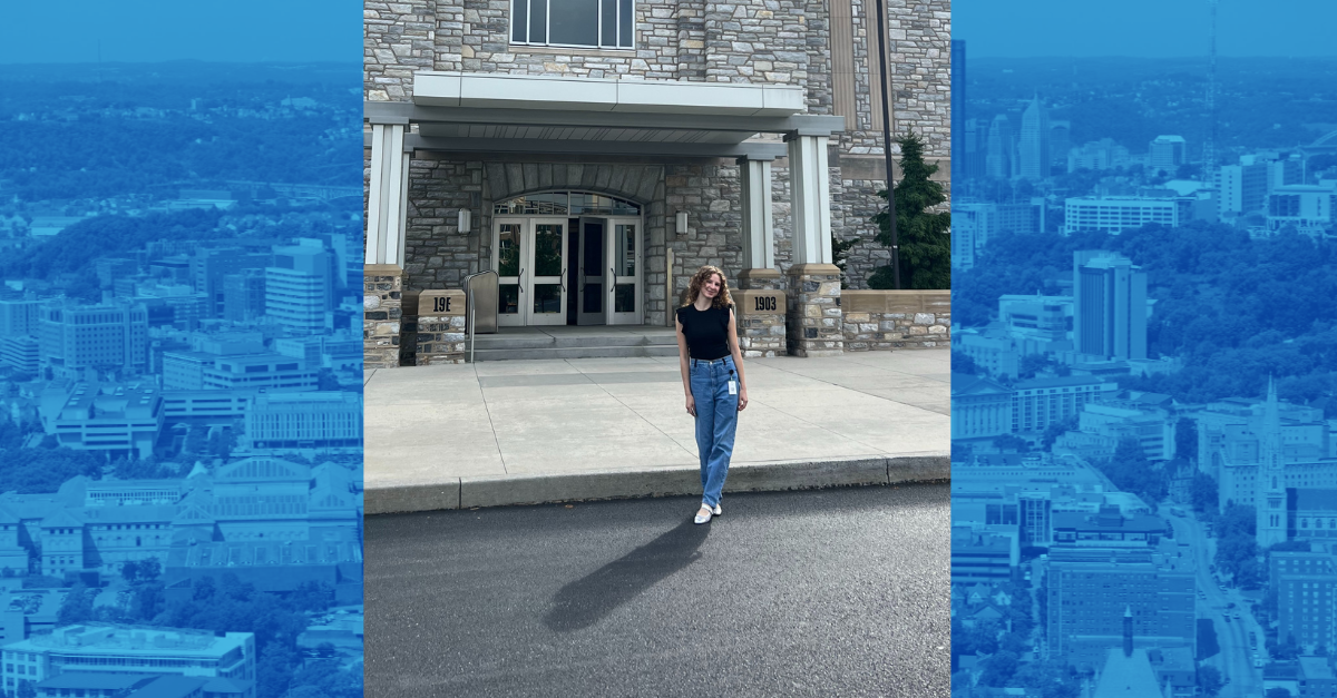 Cailey Dolata smiles in front of a building