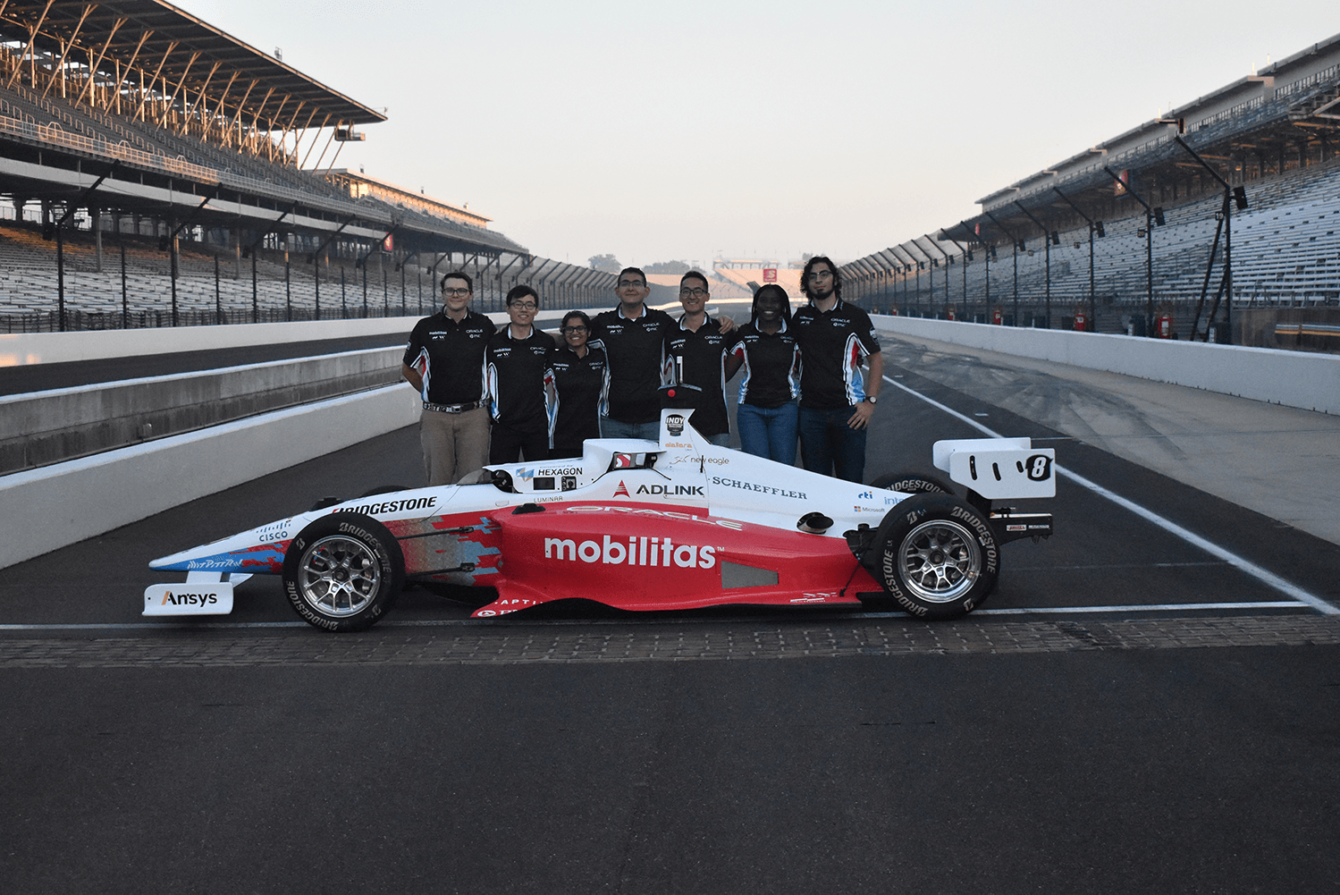 Students with a race car