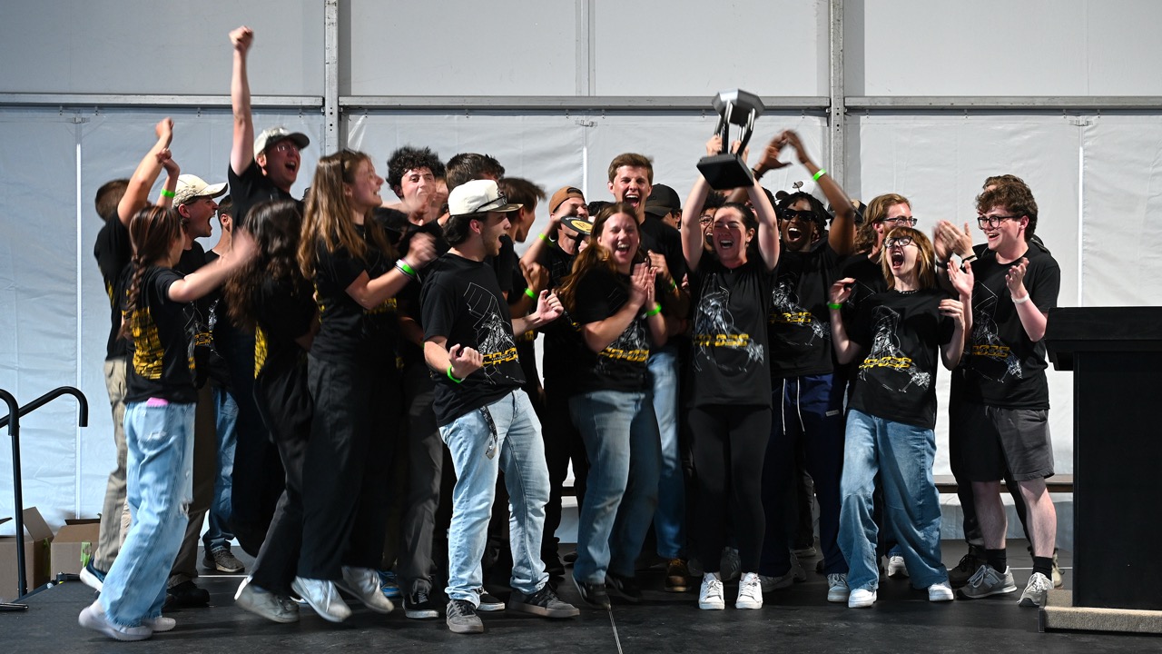 The Panther Racing team together celebrating their third-place finish in Michigan. 