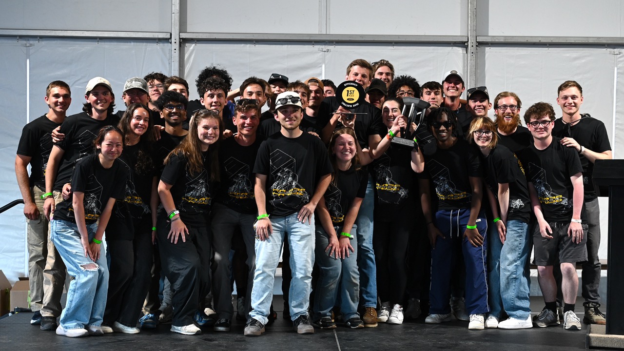 The Panther Racing team together celebrating their third-place finish in Michigan.