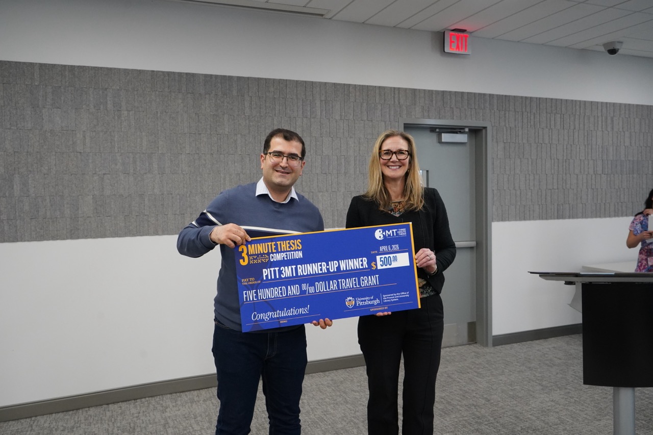 Alireza Mohammadzadeh and Amanda Godley stand together for a photo at the 3MT competition