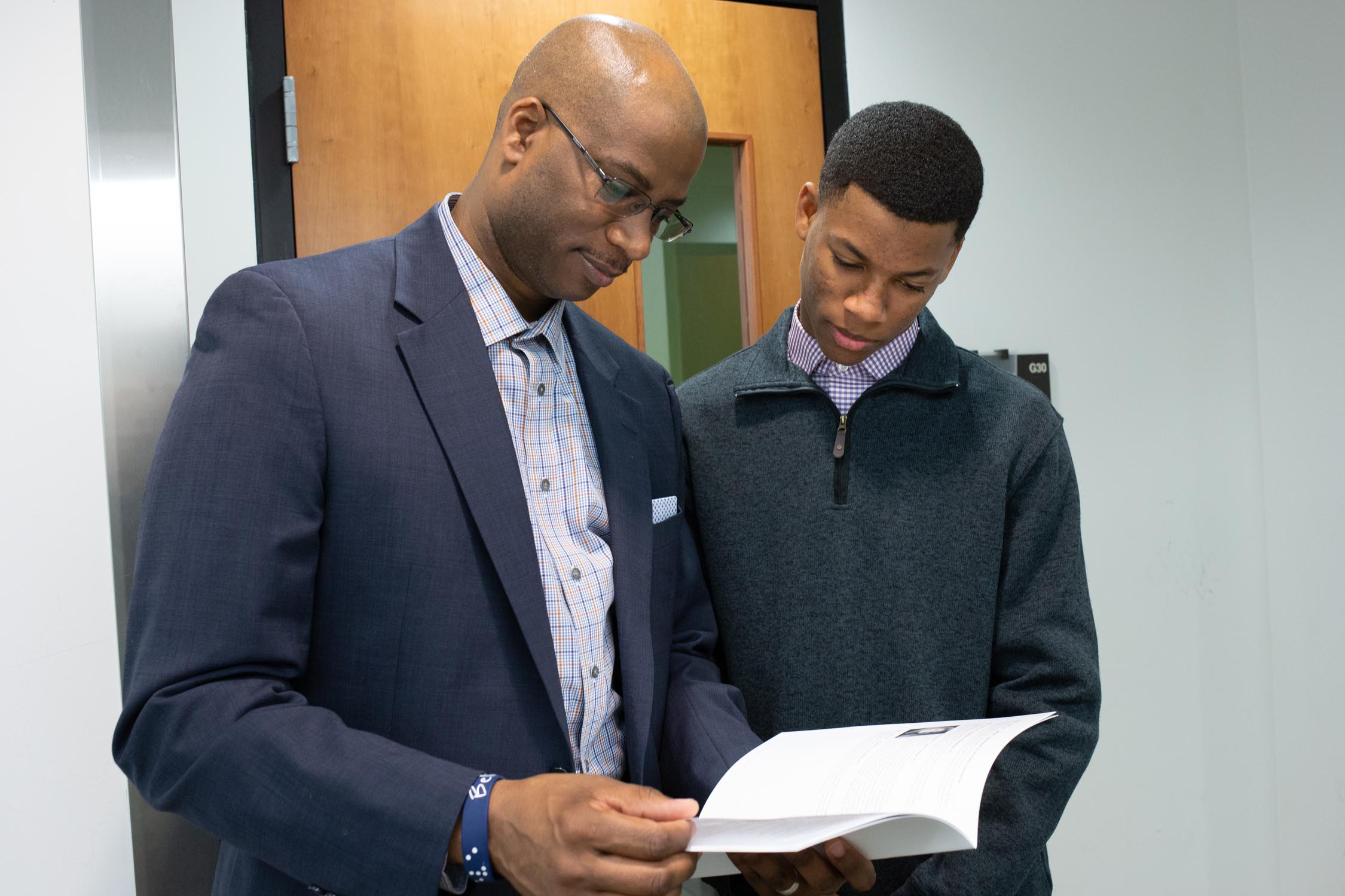 Faculty reviewing a paper with a student