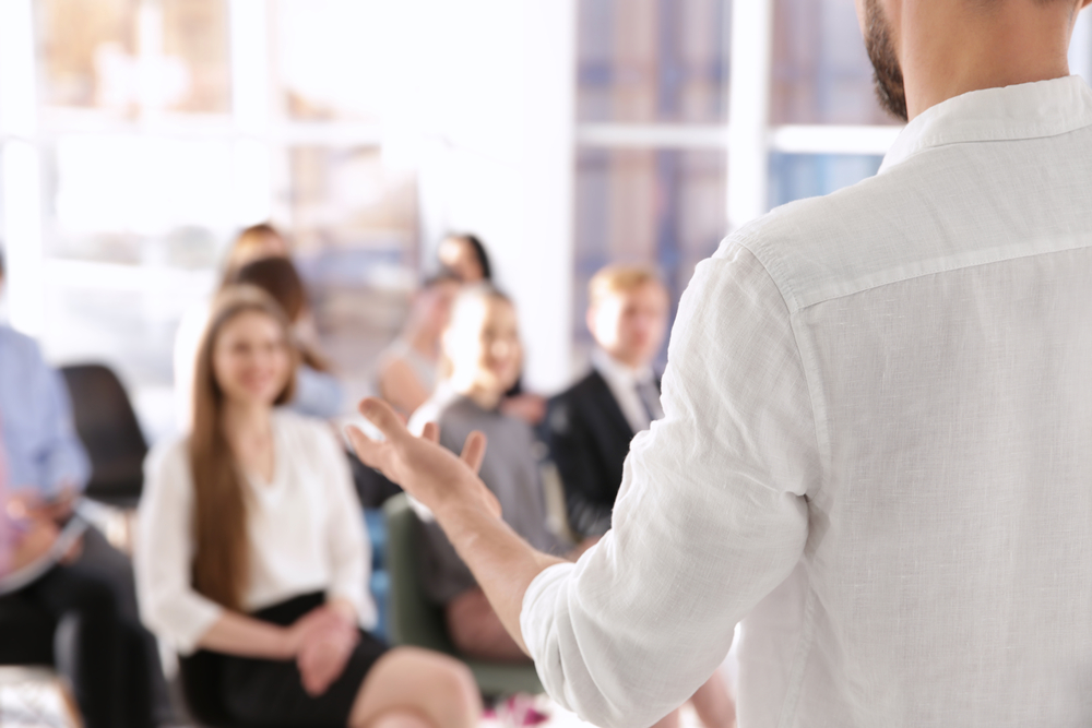  A person lecturing to a group of people