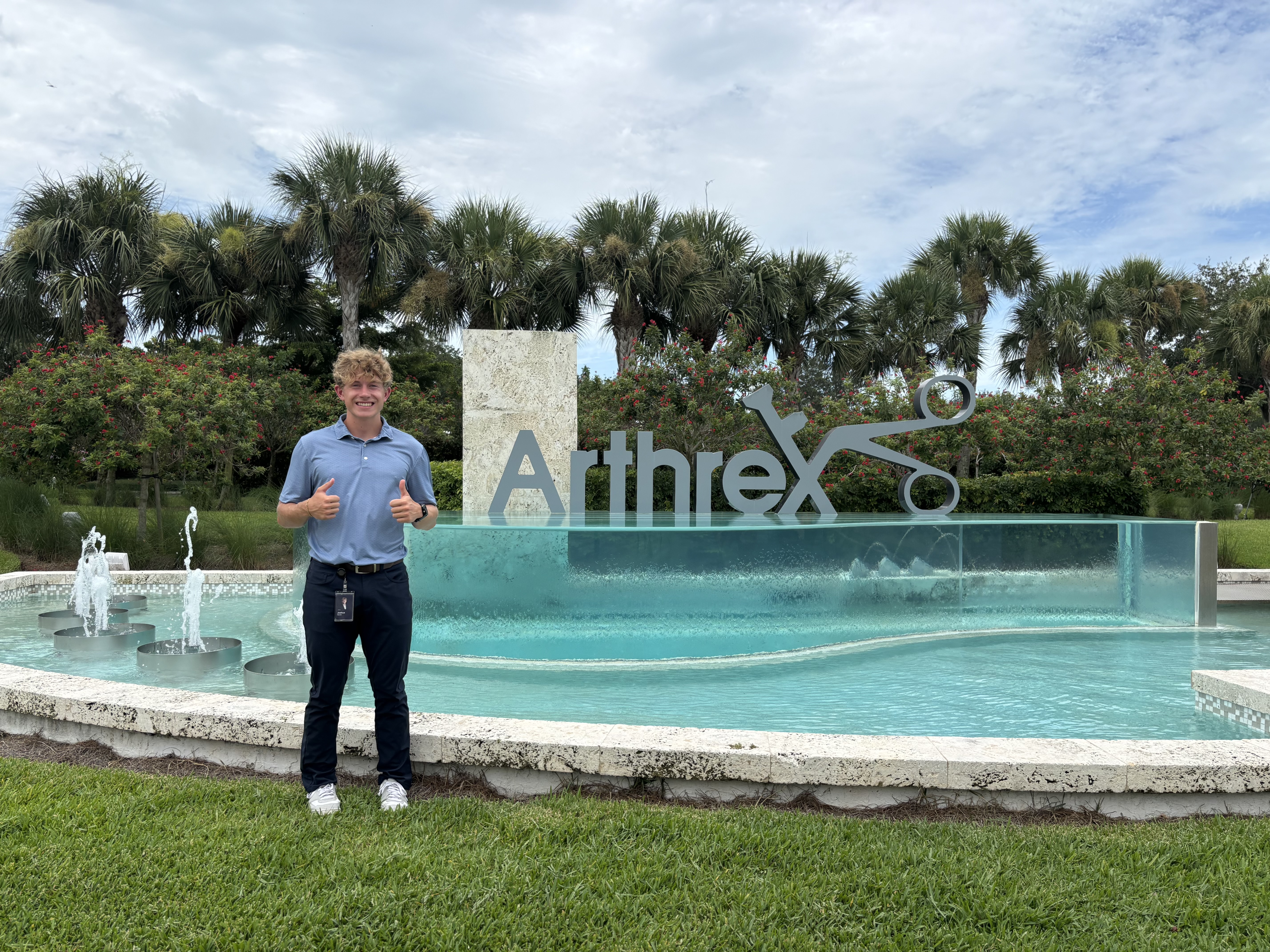 Josh Beres standing in front of Arthrex sign