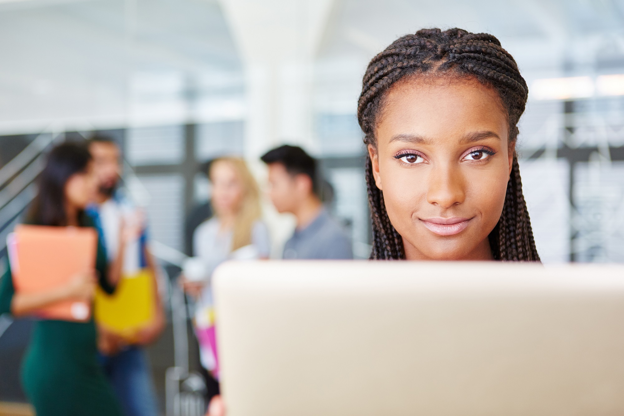 A person working on a laptop smiling