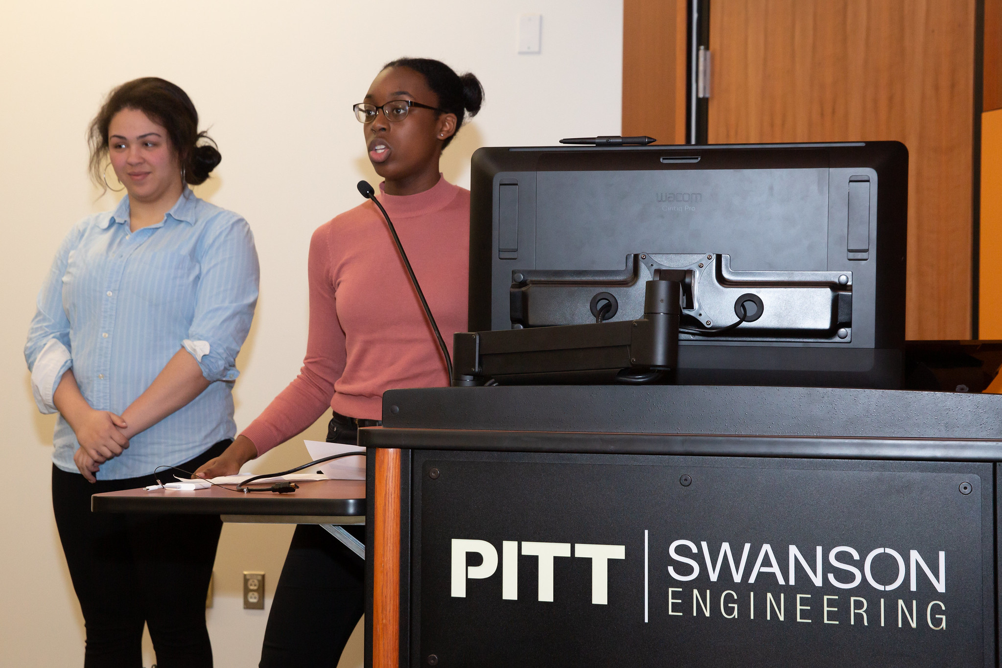 Two students presenting in a classroom