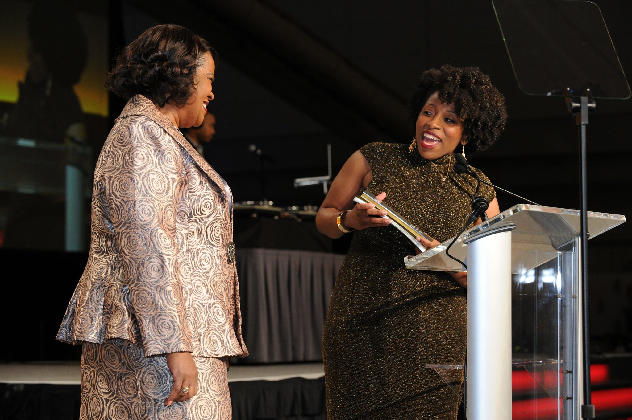 Two people on stage at an awards presentation