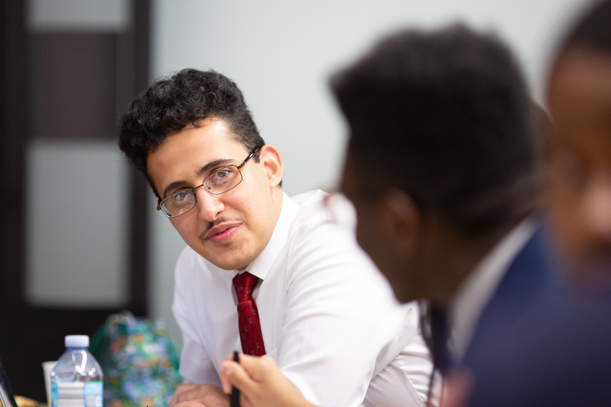 Two people talking at a desk