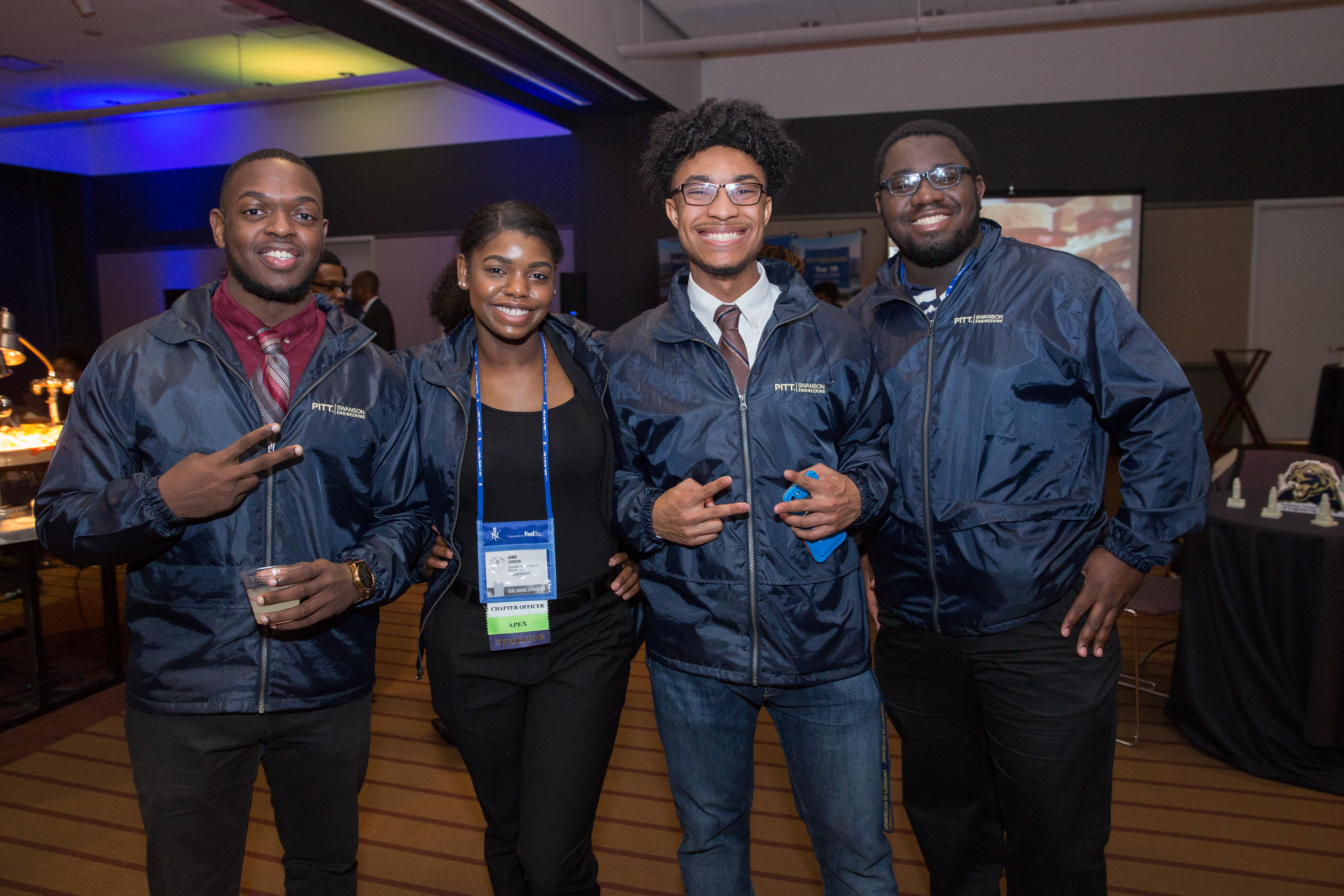 A group of students standing in a line smiling