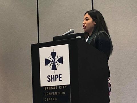 A person speaking at a SHPE podium