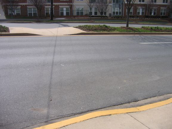 A curb ramp next to a road