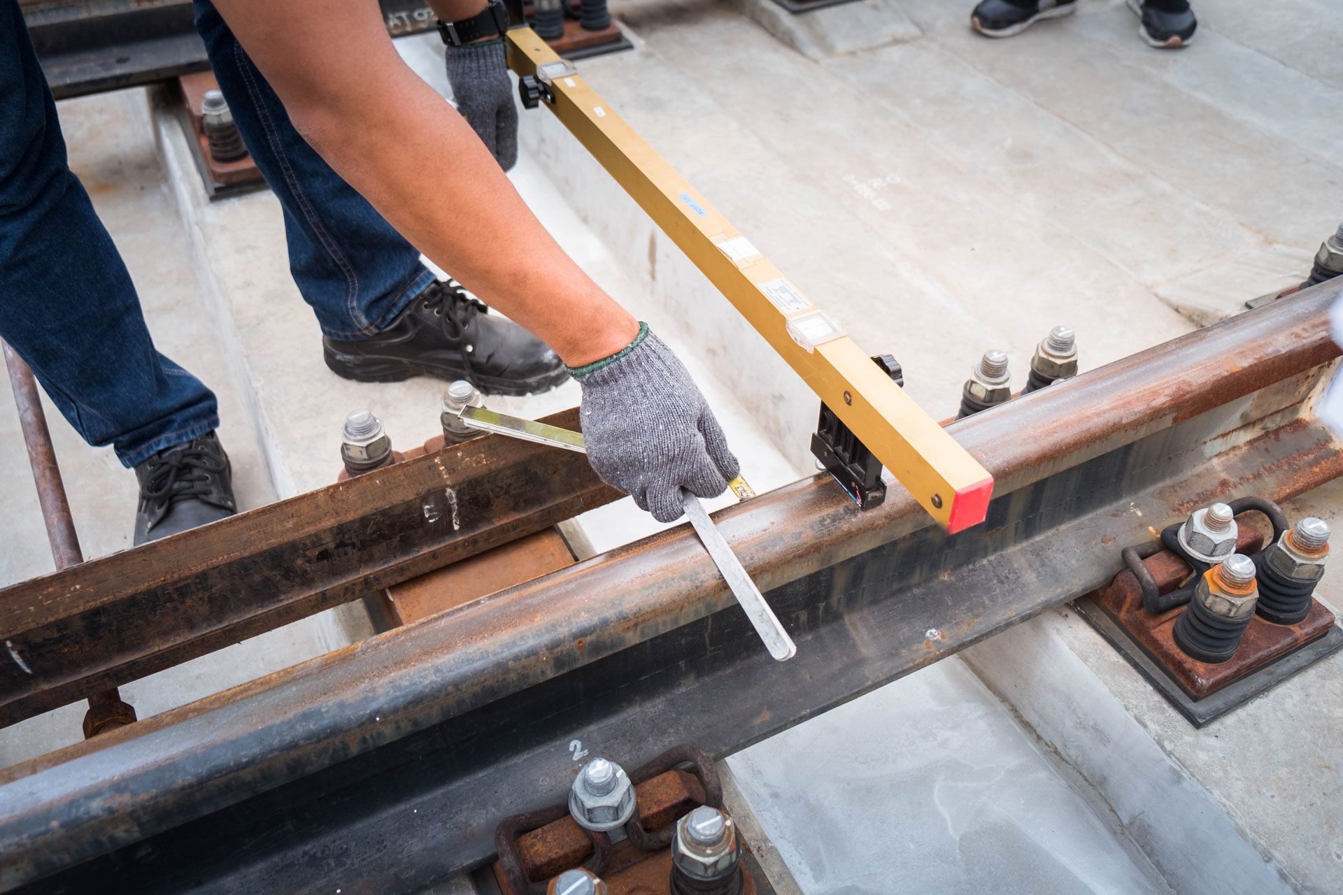 A closeup of transportation rails being measured