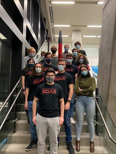 A group of students standing on a staircase wearing SOAR t-shirts